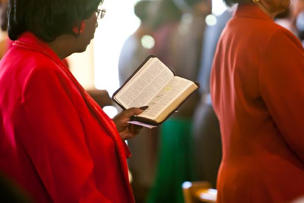 Church members read scripture together during the morning service at the First African Methodist Episcopal Church in Las Vegas on Sunday, Oct. 27, 2013.
