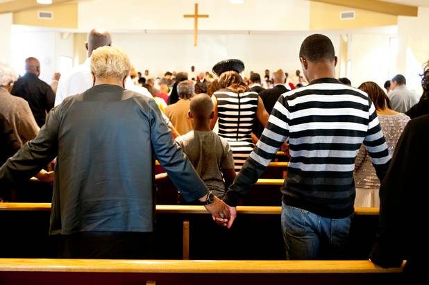 Church members join hands and bow in prayer together during the morning service at the First African Methodist Episcopal Church in Las Vegas on Sunday, Oct. 27, 2013.