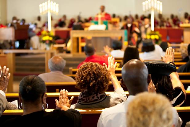 Church members raise their hands in praise during the morning service at the First African Methodist Episcopal Church in Las Vegas on Sunday, Oct. 27, 2013.
