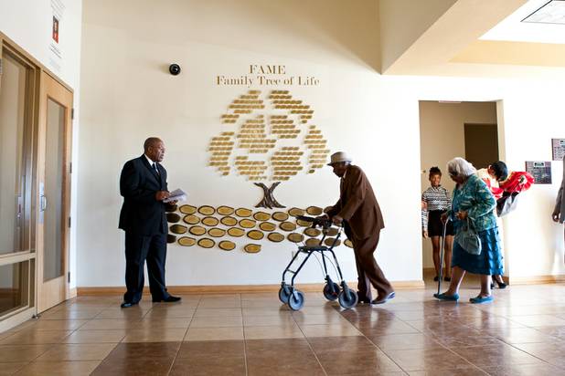 Senior usher Thomas Kendrick, left, welcomes church members into the sanctuary at the First African Methodist Episcopal Church in Las Vegas on Sunday, Oct. 27, 2013.