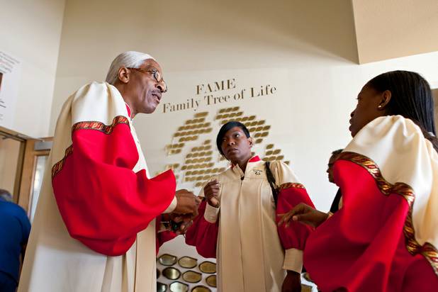 Organist Calvin Martin discusses the morning song list with members of the choir Stephanie Liferidge and Stephanie Montoya, right, prior to the service at the First African Methodist Episcopal Church in Las Vegas on Sunday, Oct. 27, 2013.