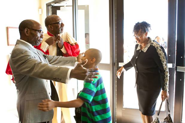 Pastor Dr. Ralph Williamson greets churchgoers as they arrive for the morning service at the First African Methodist Episcopal Church in Las Vegas on Sunday, Oct. 27, 2013.