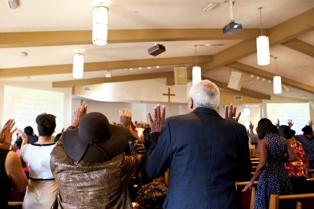 Church members raise their hands in praise during the morning service at the First African Methodist Episcopal Church in Las Vegas on Sunday, Oct. 27, 2013.