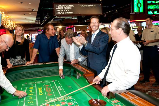 CEO Seth Schorr applauds a winning bet during the opening of the Downtown Grand Las Vegas Hotel and Casino in Las Vegas Sunday, October 27, 2013.