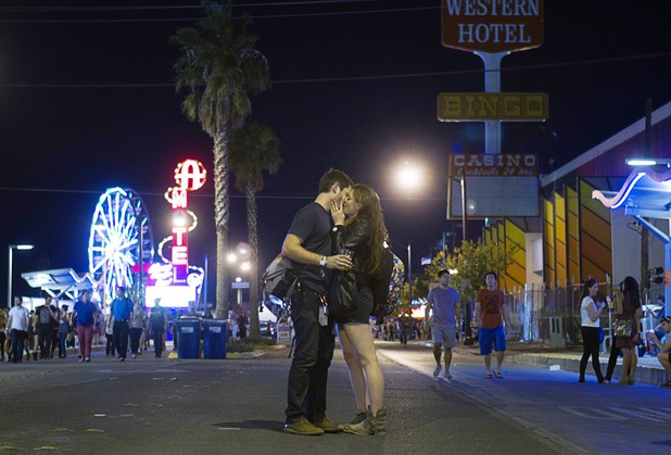 A couple kiss on Fremont Street during the Life is Beautiful Festival in downtown Las Vegas Sunday, Oct. 27, 2012.