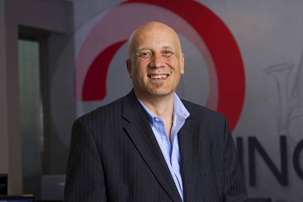 Ben Jones, vice president/director of sales for Jennifer Web Design, poses in the company's workspace in the Switch inNEVation Center Monday, Oct. 28, 2013.