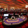 In this Sept. 20, 2012, file photo, croupiers sit at a baccarat gaming table inside a casino during the opening day of Sheraton Macao Hotel at the Sands Cotai Central in Macau. In China, the world’s largest gambling market, casino debts are not legally enforceable. Over the summer, a bilingual Chinese website posted a list of high rollers the site said were dodging their gambling debts.
