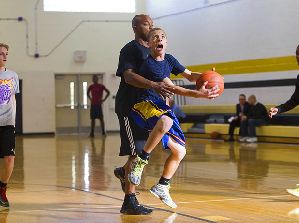 Assistant coach Jerry Glover covers Aariyen McGriff during intramurals at Clark High School Wednesday, Oct. 30, 2013.