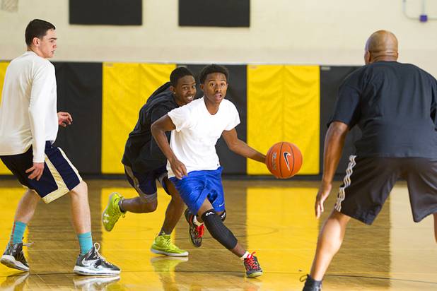 Sophomore Leslie Long, center, takes the ball downcourt during intramurals at Clark High School Wednesday, Oct. 30, 2013.