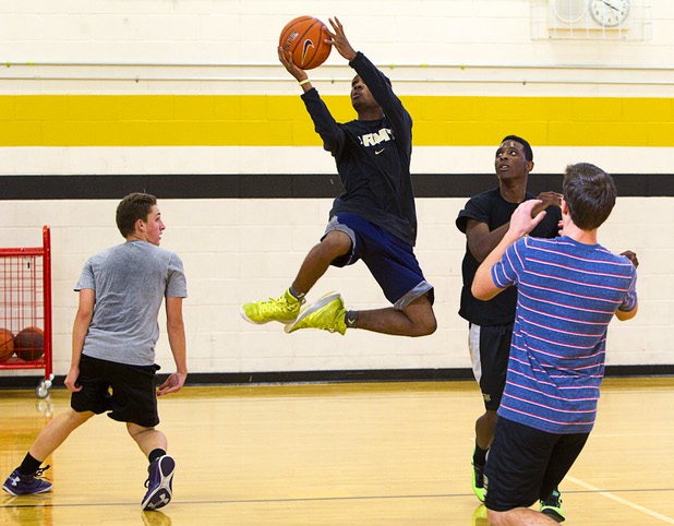Dominique Washington, center, drives to the basket during intramurals at Clark High School Wednesday, Oct. 30, 2013.