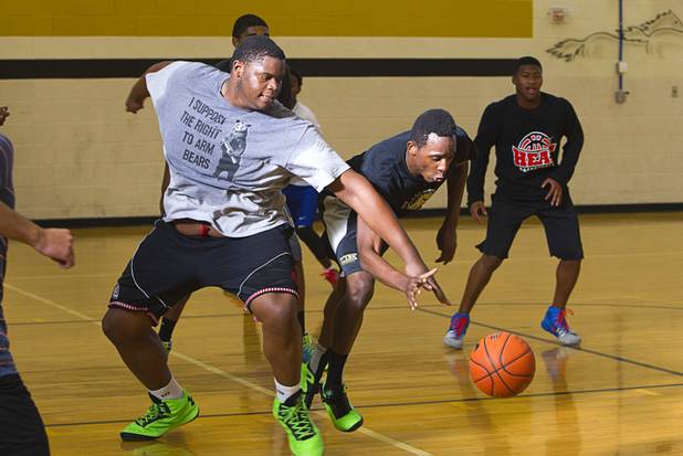Justin Harris, left, and Dickenzy Saintil go after a loose ball during intramurals at Clark High School Wednesday, Oct. 30, 2013.