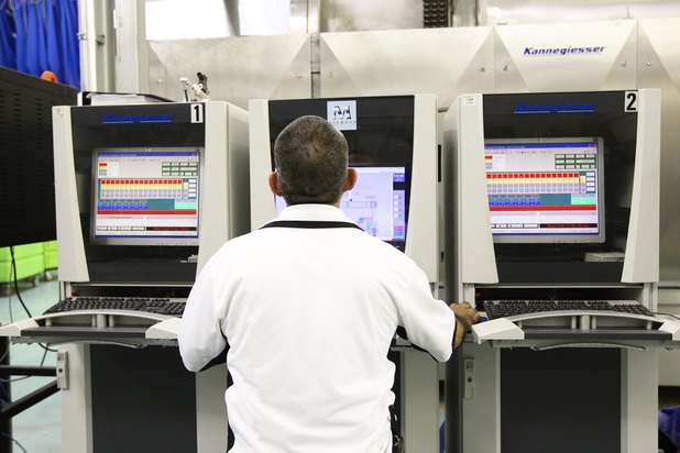 A tunnel washer operator oversees the production equipment at Apex Linen in Las Vegas Tuesday, October 30, 2013.