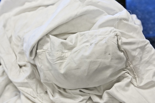 A cleverly sewn-in pocket containing an ink packet placed by an unknown perpetrator is shown in a sheet during a walk-through of Apex Linen in Las Vegas Tuesday, October 30, 2013.