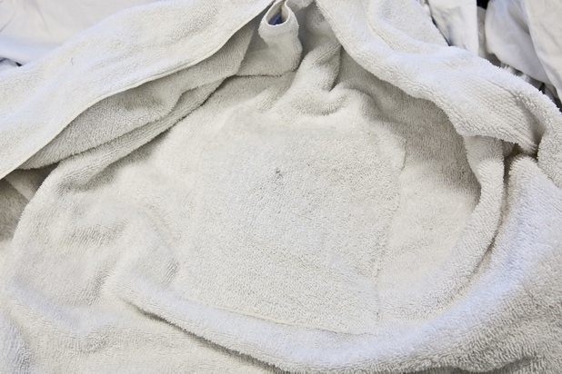 A cleverly sewn-in pocket containing an ink packet placed by an unknown perpetrator is shown in a towel during a walk-through of Apex Linen in Las Vegas Tuesday, October 30, 2013.