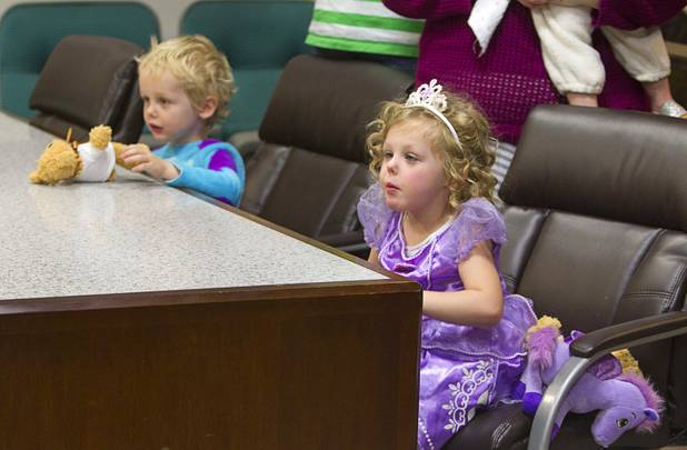 Skyler, 3, and Sasha Green, 4, are dressed in Halloween costumes as their parents adopt Sydney Green, 2, during a Halloween adoption day at Family Court Thursday, Oct. 31, 2013.