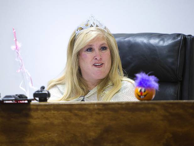 Judge Cynthia Giuliani, dressed as a fairy godmother, waves her wand during a Halloween adoption day at Family Court Thursday, Oct. 31, 2013. Giuliani dressed up last year on Halloween and got so much positive reaction that she decided to dress up again, she said.