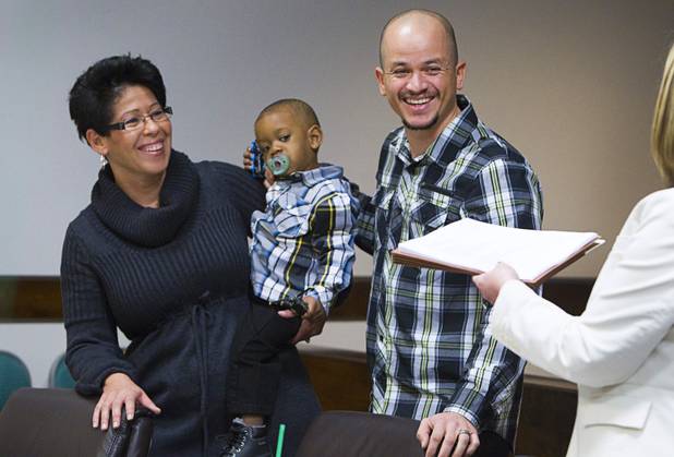 Amarilis and Edgar Vega adopt Kyran, 2, during a Halloween adoption day at Family Court Thursday, Oct. 31, 2013.