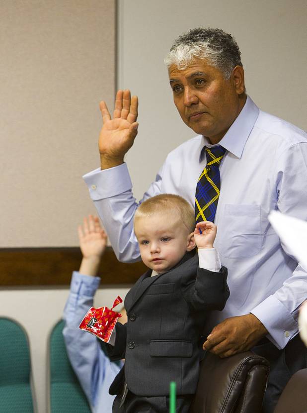Gerardo Torres, 2, and his father Moses are sworn in during a Halloween adoption day at Family Court Thursday, Oct. 31, 2013.
