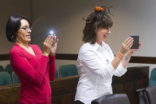 Jillian Templeton, left, and Clark County social worker Kim Twining take photos during a Halloween adoption day at Family Court Thursday, Oct. 31, 2013.