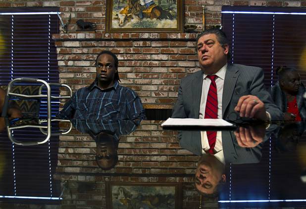 Antoine Hodges, left, is joined by his lawyer Cal Potter Friday as they talk about his filing of a federal lawsuit against the Metro Police department Friday, Nov. 1, 2013. Hodges was mistaken as homicide suspect and shot by a Metro Police officer last week.