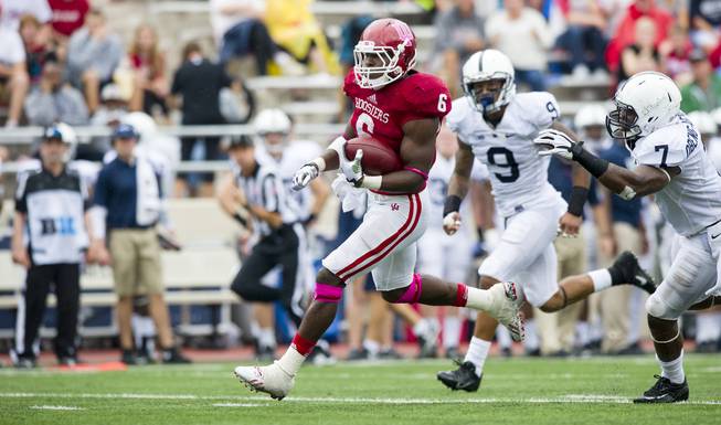 Indiana's Tevin Coleman (6) breaks through the Penn State defense and rushes the ball into the end zone for a touchdown during the second half of an NCAA college football game, Saturday, Oct. 5, 2013, in Bloomington, Ind. Indiana defeated Penn State 44-24.