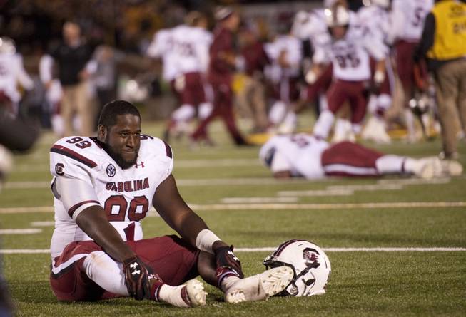 South Carolina's Kelcy Quarles smiles as he sits on the field after defeating Missouri 27-24 in overtime of an NCAA college football game Saturday, Oct. 26, 2013, in Columbia, Mo.