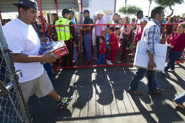 People line up at an entrance to the Broadacres Marketplace & Events Center Sunday Nov. 3, 2013.