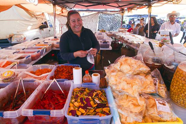 Vendor Clara Perez mans a booth at the Broadacres Marketplace & Events Center Sunday Nov. 3, 2013.