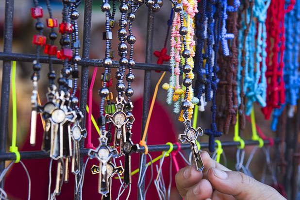 A customer looks at a rosary at the Broadacres Marketplace & Events Center Sunday Nov. 3, 2013.