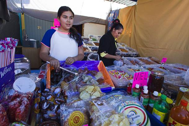 Daniela Madrigal Ocampo, 11, and her mother Maria Ocampo sell food items from their booth at the Broadacres Marketplace & Events Center Sunday Nov. 3, 2013.