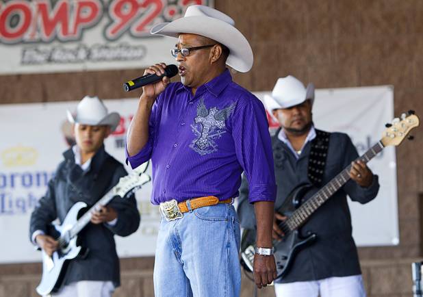 Broadacres regular Jose Martinez joins members of Conjunto Pena Blanca for a song at the Broadacres Marketplace & Events Center Sunday Nov. 3, 2013. Martinez comes to the marketplace almost every Sunday, he said.