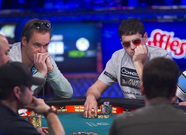 Mark Newhouse, right, 28, a poker professional from Los Angeles, competes during the final table of the World Series of Poker $10,000 buy-in no-limit Texas Hold 'Em tournament at the Rio Monday, Nov. 4, 2013. The 2013 "November Nine" are competing for a share of $26,662,046 of prize money including $8,359,531 for first place.