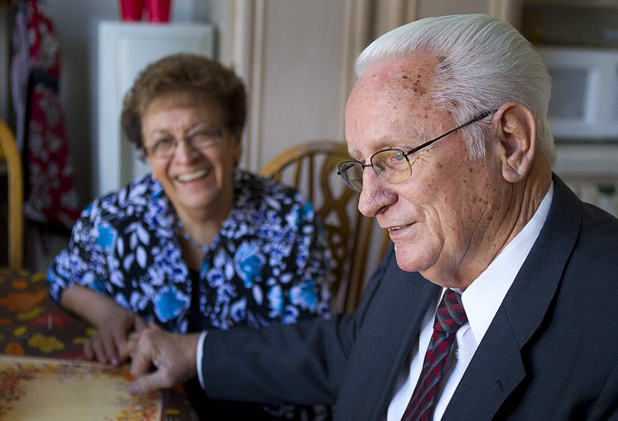 Lanny Littlefield shows how he used to hold hands with Gloria in high school during an interview at their home in Henderson Tuesday, Nov. 5, 2013. The couple, graduates of Basic High School, will leave soon for a LDS church leadership mission in Knoxville, Tenn.