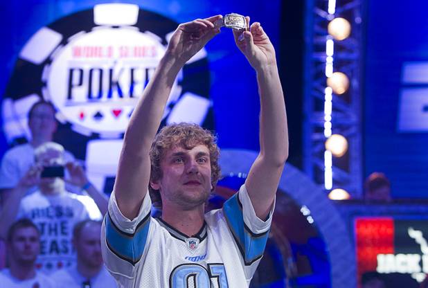 Ryan Riess, 23, a poker professional from East Lansing, Mich., holds up his championship bracelet after winning the World Series of Poker $10,000 buy-in no-limit Texas Hold 'Em tournament at the Rio Tuesday, Nov. 5, 2013.