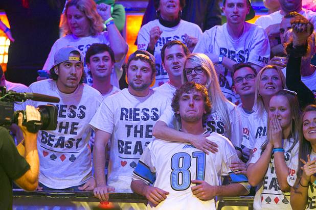 Ryan Riess, 23, a poker professional from East Lansing, Mich., waits for his final cards with supporters before winning the World Series of Poker $10,000 buy-in no-limit Texas Hold 'Em tournament at the Rio Tuesday, Nov. 5, 2013.