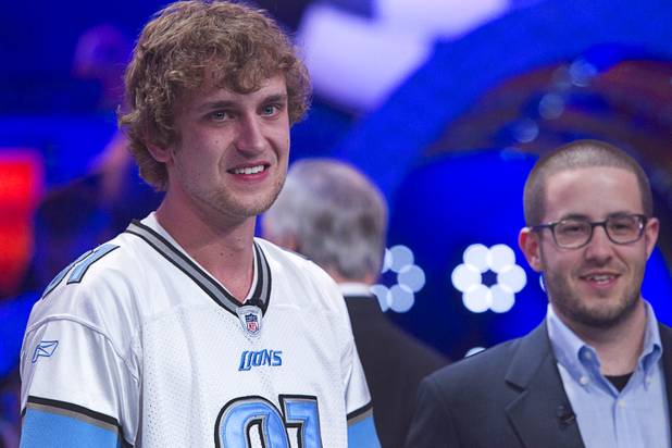 Ryan Riess, 23, a poker professional from East Lansing, Mich., waits for a post-event ceremony after winning the World Series of Poker $10,000 buy-in no-limit Texas Hold 'Em tournament at the Rio Tuesday, Nov. 5, 2013. Greg Merson, 2102 WSOP main event winner, is at right.