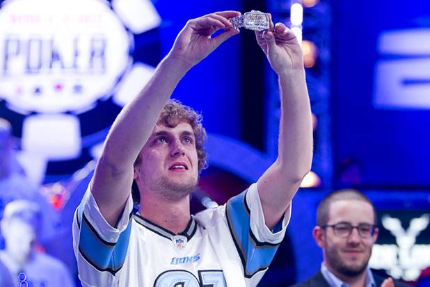 Ryan Riess, 23, a poker professional from East Lansing, Mich., holds up his championship bracelet after winning the World Series of Poker $10,000 buy-in no-limit Texas Hold 'Em tournament at the Rio Tuesday, Nov. 5, 2013.