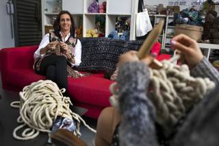 (from left) Brenda Johannessen of Unwind Knitting knits while watching and guiding Jen Taler as she learns to knit with merino wool from Loopy Mango on Tuesday, Nov. 5, 2013.  L.E. Baskow