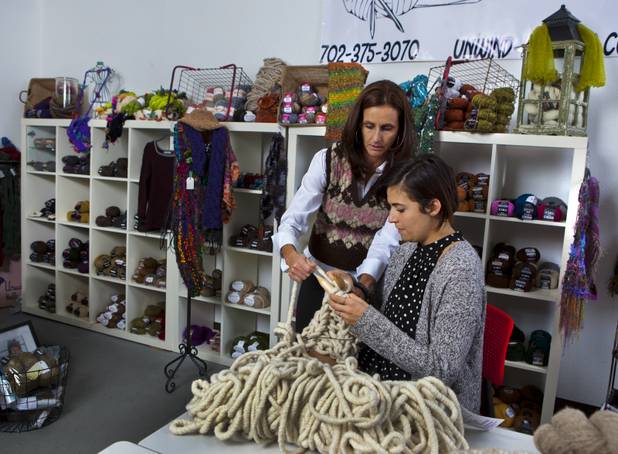 Brenda Johannessen, left, of Unwind Knitting inside the Stitch Factory teaches Jen Taler to knit with merino wool from Loopy Mango on Tuesday, Nov. 5, 2013. 