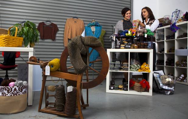 Brenda Johannessen (right) with Unwind Knitting located Inside the Stitch Factory talks with Jen Taler Tuesday about the various yarns which van be selected to knit great scarves. The shop offers a selective supply of luxury yarns and classes for knitting and crocheting. Nov. 5, 2013.  L.E. Baskow