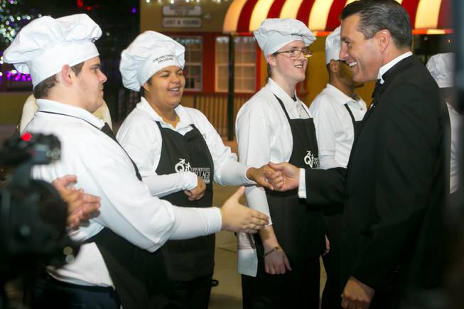 Gov. Brian Sandoval is greeted by students of Opportunity Village’s Job Discovery Program during their 2013 Camelot Gala on Thursday, Nov. 7, 2013.