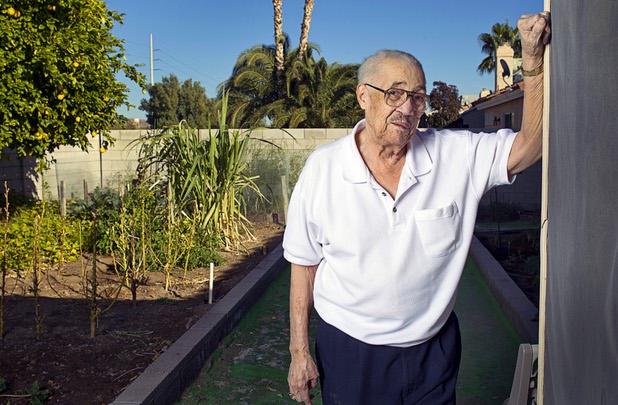 World War II veteran Harvey Johnson, 90, poses in his backyard Sunday, Nov. 10, 2013. Johnson served in a hospital unit in Papua New Guinea and in the Philippines, he said.