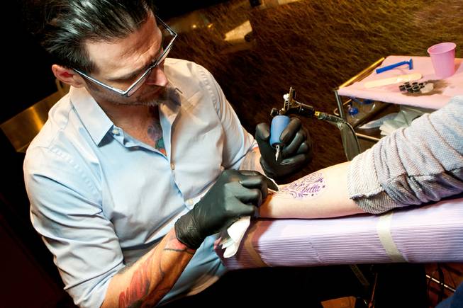 Joey Hamilton of Club Tattoo - Tattoo artist Joey Hamilton dabs ink while  creating a tattoo ... -