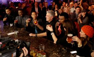 Anthony Bourdain, third from right, films his CNN series “Parts Unknown” with chef Roy Choi, actor Wendell Pierce, CNN anchor Don Lemon, chef Marcus Samuelsson and comedienne Bonnie McFarlane at Atomic Liquors on Sunday, Nov. 10, 2013, in downtown Las Vegas. The woman at right was not part of the filming.