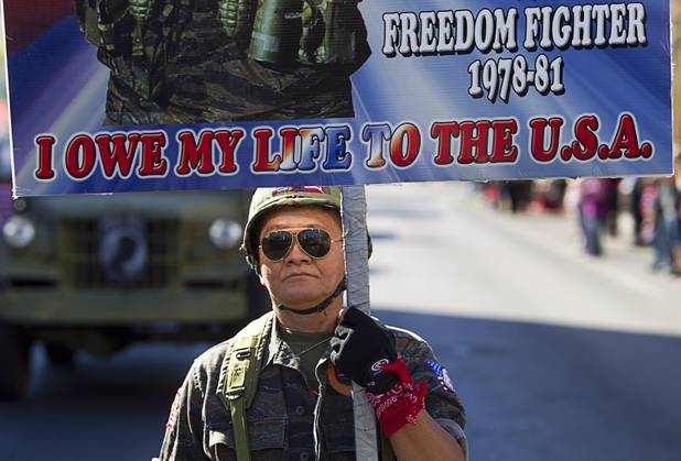 Sothy Seang, owner of the Donut Hut, marches in the Veterans Day parade in downtown Las Vegas Monday, Nov. 11, 2013. Seang fought with the Cambodian army against the Viet Cong during the Vietnam War.