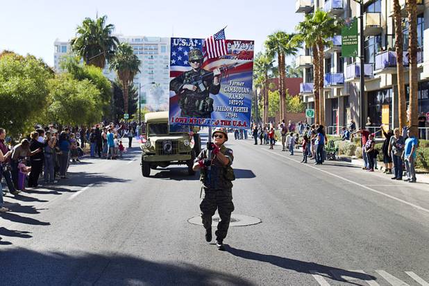 Sothy Seang, owner of the Donut Hut, marches in the Veterans Day parade in downtown Las Vegas Monday, Nov. 11, 2013. Seang fought with the Cambodian army against the Viet Cong during the Vietnam War.