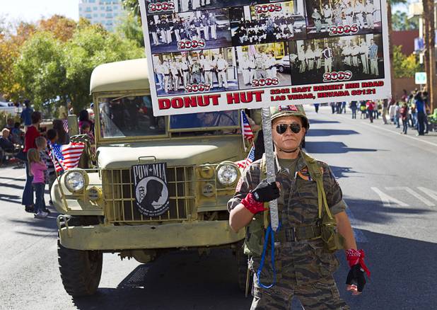 Sothy Seang, owner of the Donut Hut, marches in the Veterans Day parade in downtown Las Vegas Monday, Nov. 11, 2013. Seang fought with the Cambodian army against the Viet Cong during the Vietnam War.