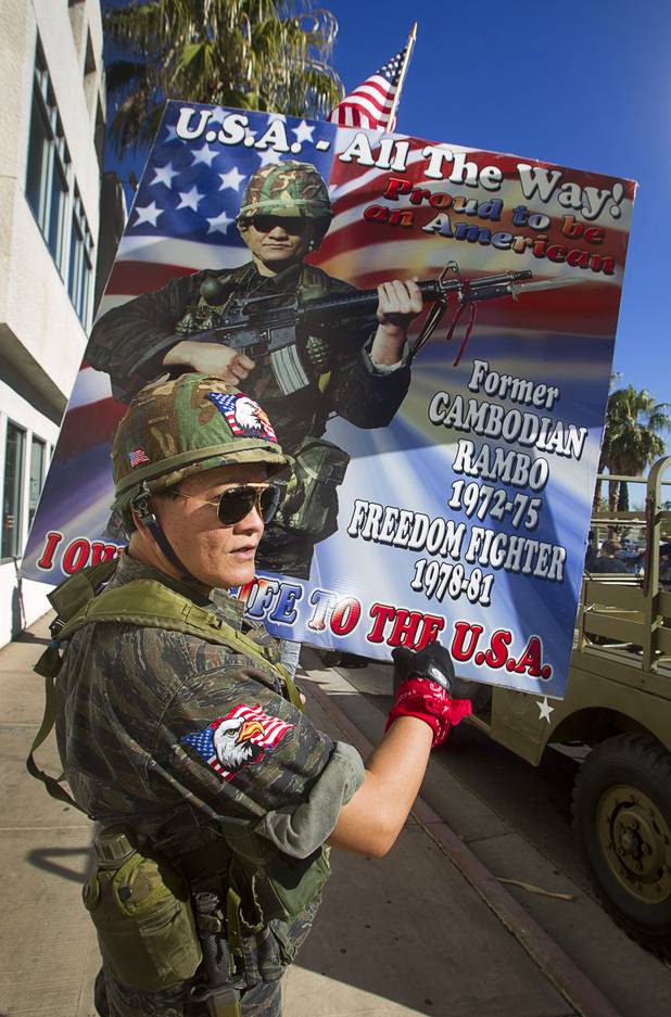 Sothy Seang, owner of the Donut Hut, explains his sign during an interview before marching in the Veterans Day parade in downtown Las Vegas Monday, Nov. 11, 2013. Seang fought with the Cambodian army against the Viet Cong during the Vietnam War.