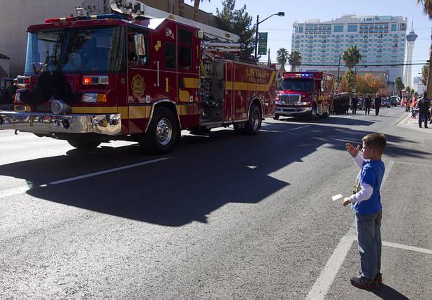 Tristen Shuberda, 6, blows kisses to parade participants during the annual Veterans Day parade in downtown Las Vegas Monday, Nov. 11, 2013.