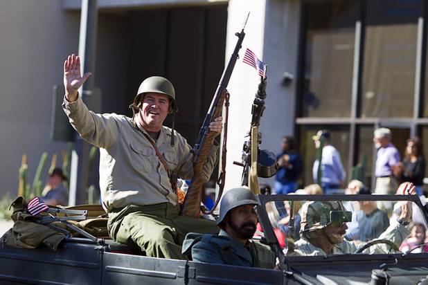 Mervin Fried waves from a military vehicleduring the annual Veterans Day parade in downtown Las Vegas Monday, Nov. 11, 2013.